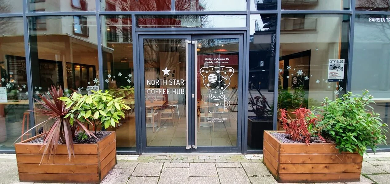 An image of the North Star Coffee window and door graphics and signage.